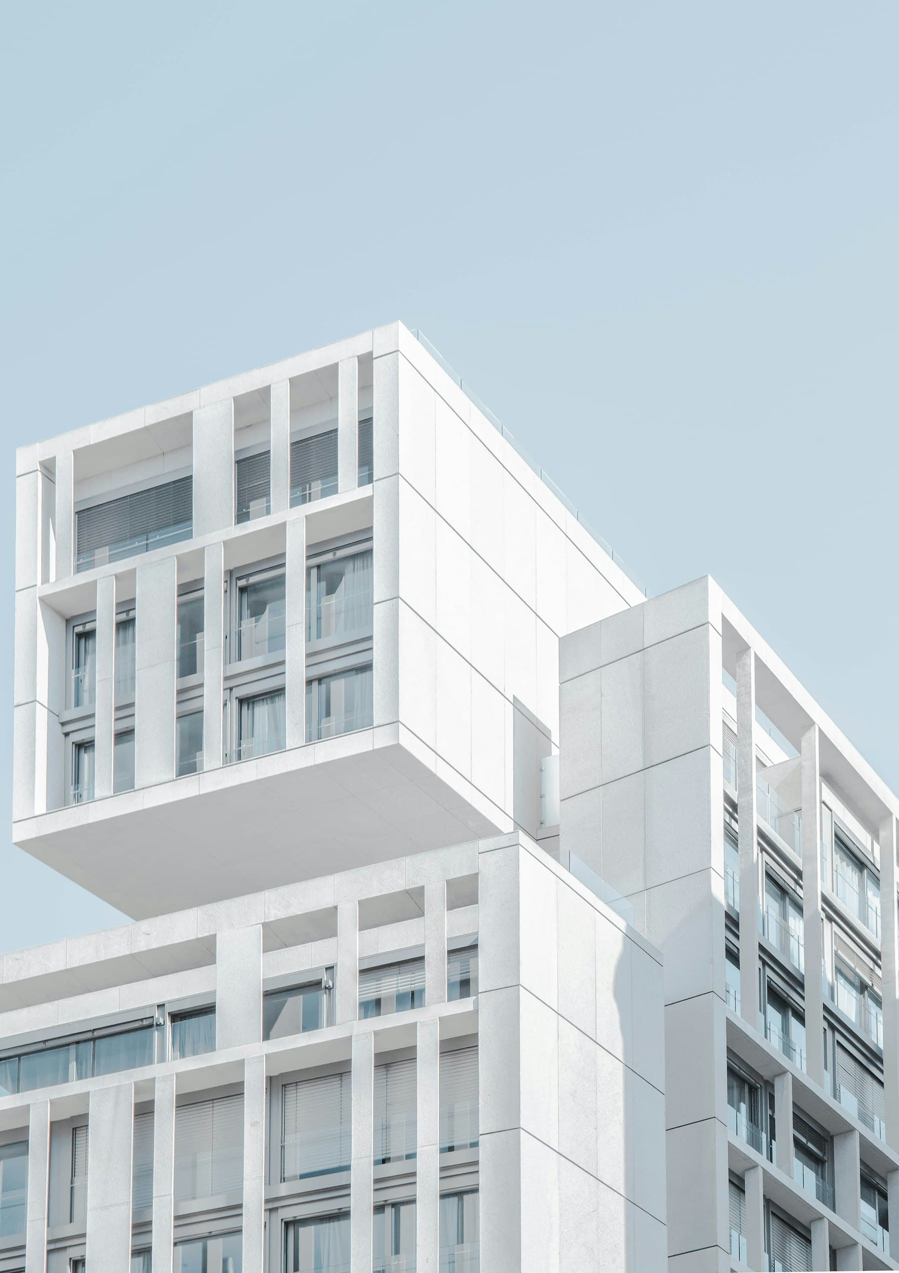 White modernist volumes against a bright sky