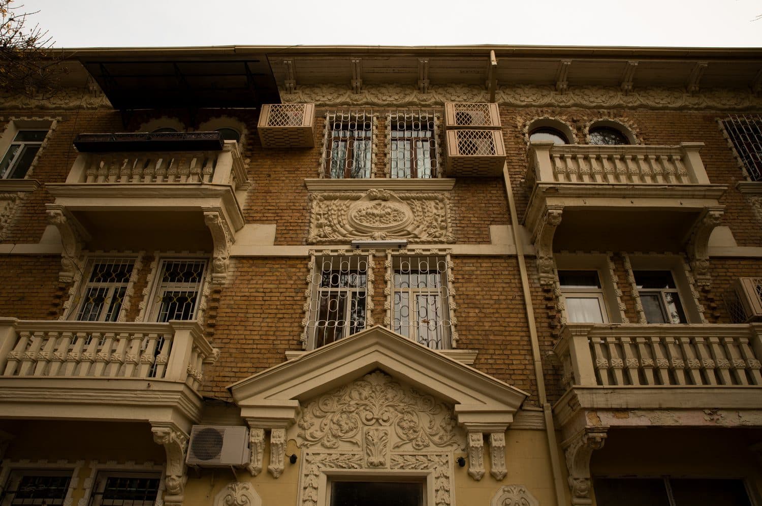 A carved plaster façade on an older Tashkent apartment building